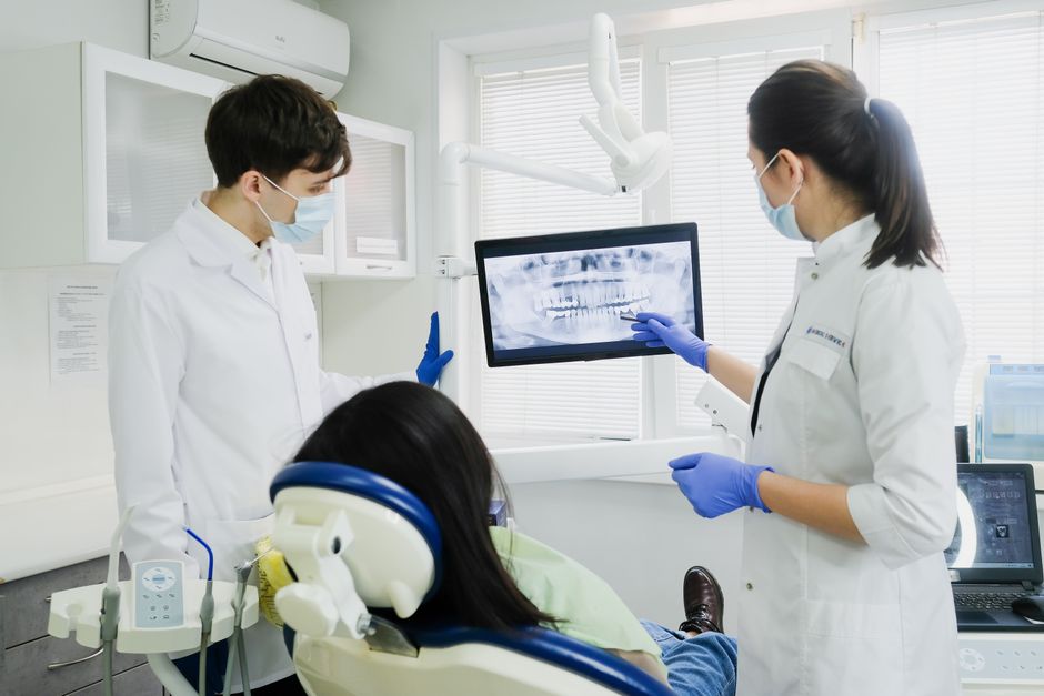 Dentists reviewing a dental X-ray with a patient