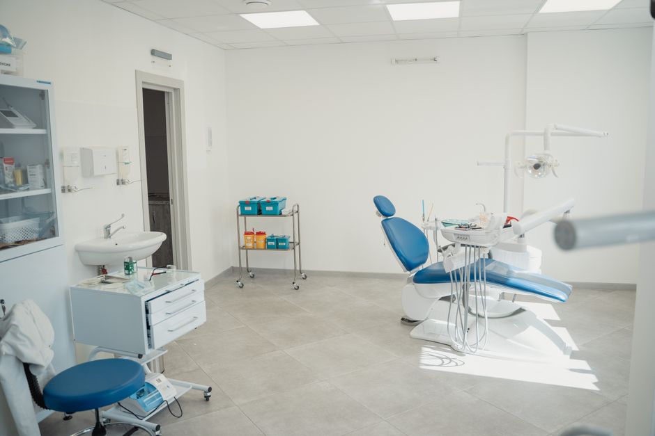 Bright dental treatment room with a chair and equipment